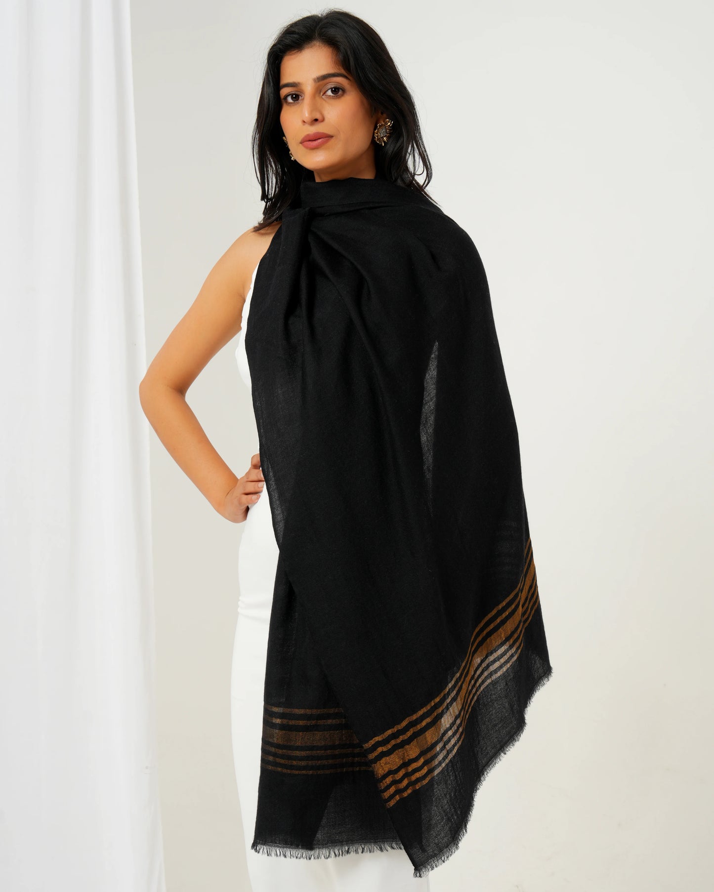 Cashmere stole in black base with golden stripes