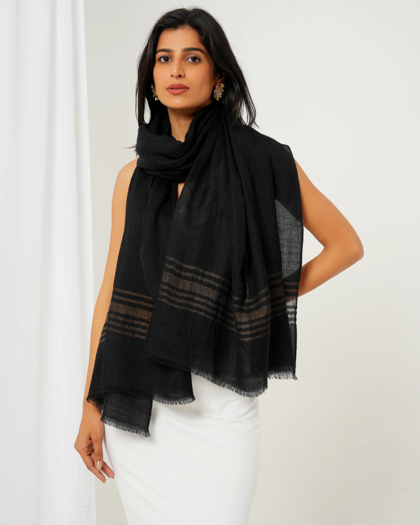Cashmere stole in black base with golden stripes