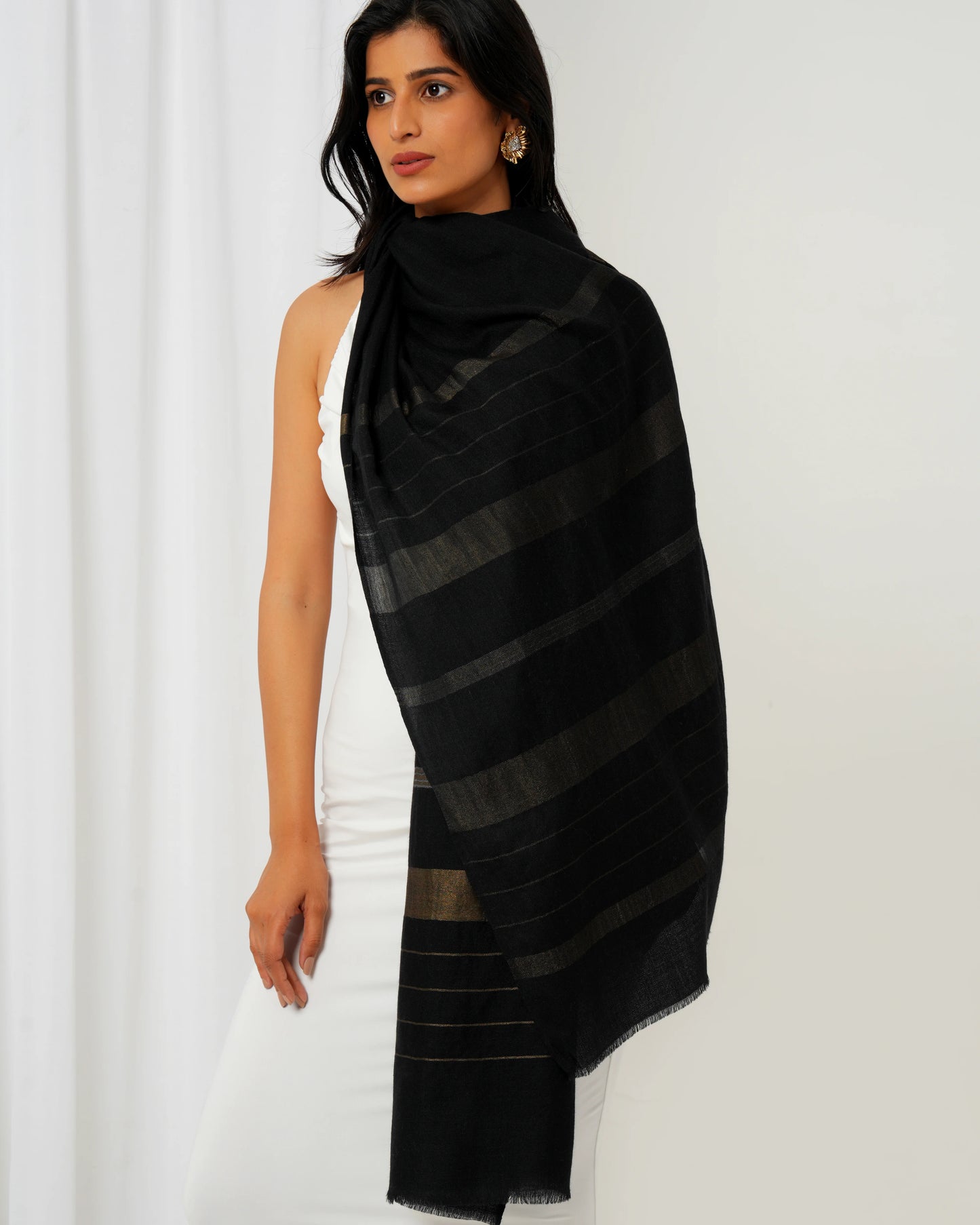 Cashmere stole in black base and multi shaped stripes in golden
