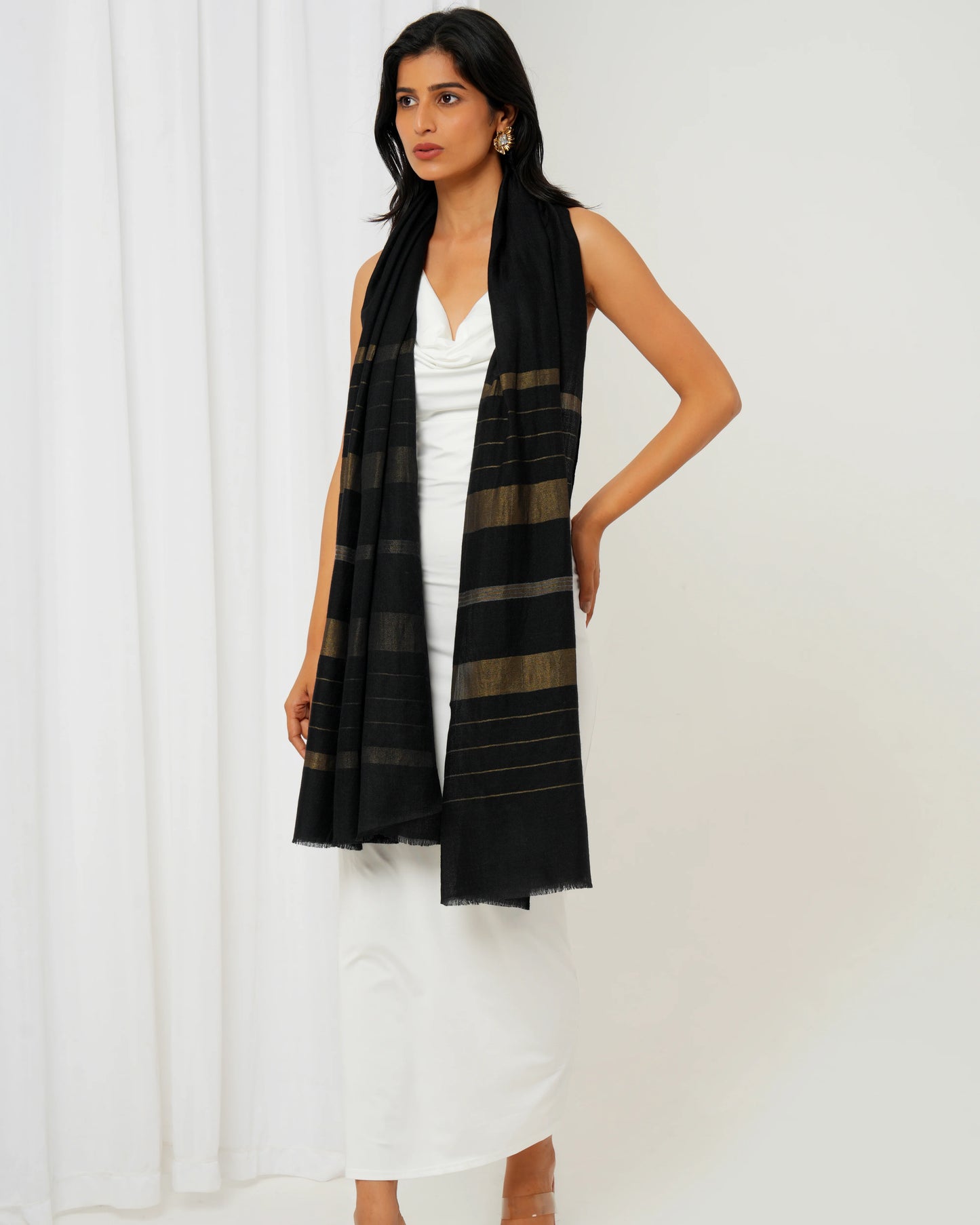 Cashmere stole in black base and multi shaped stripes in golden