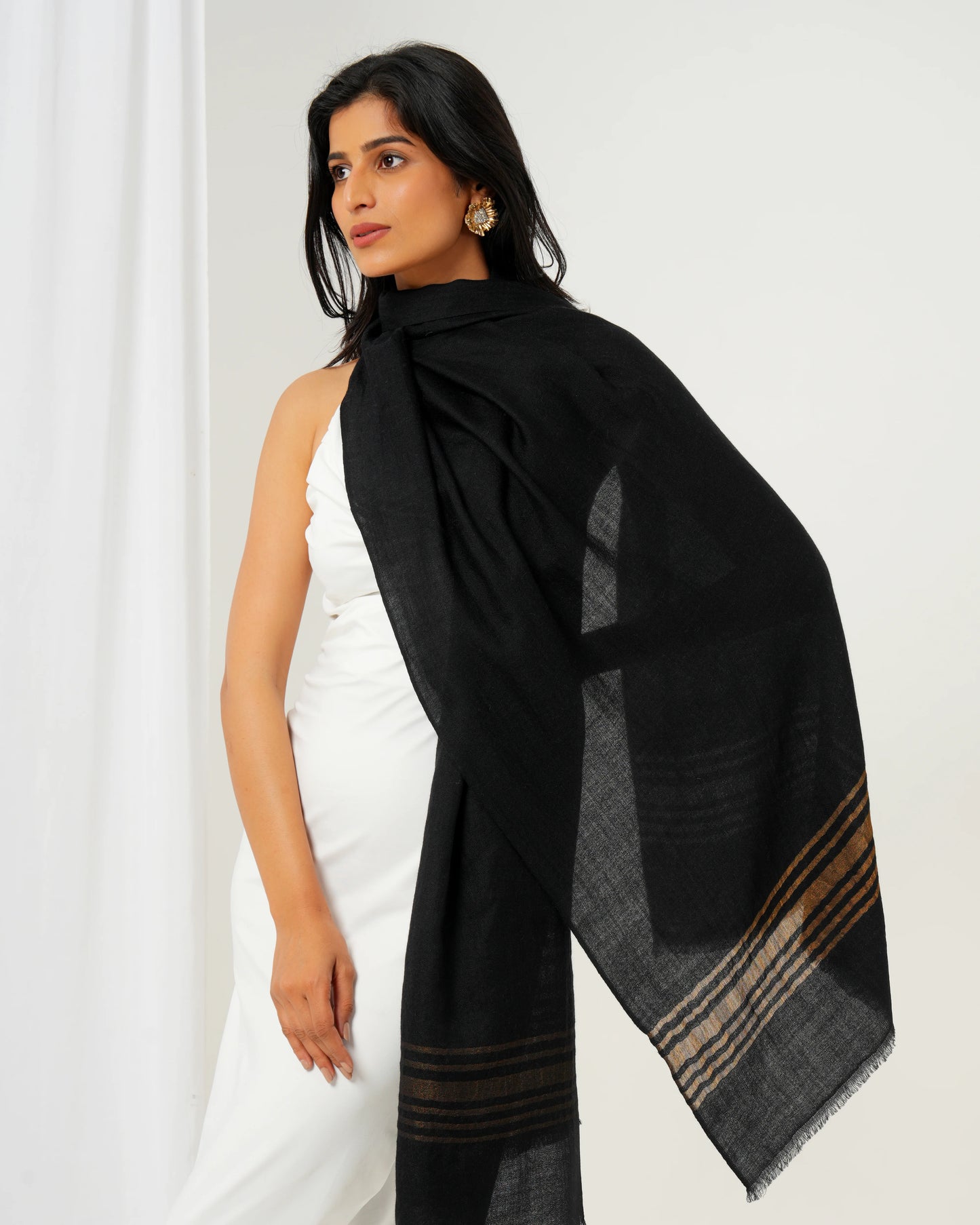 Cashmere stole in black base with golden stripes