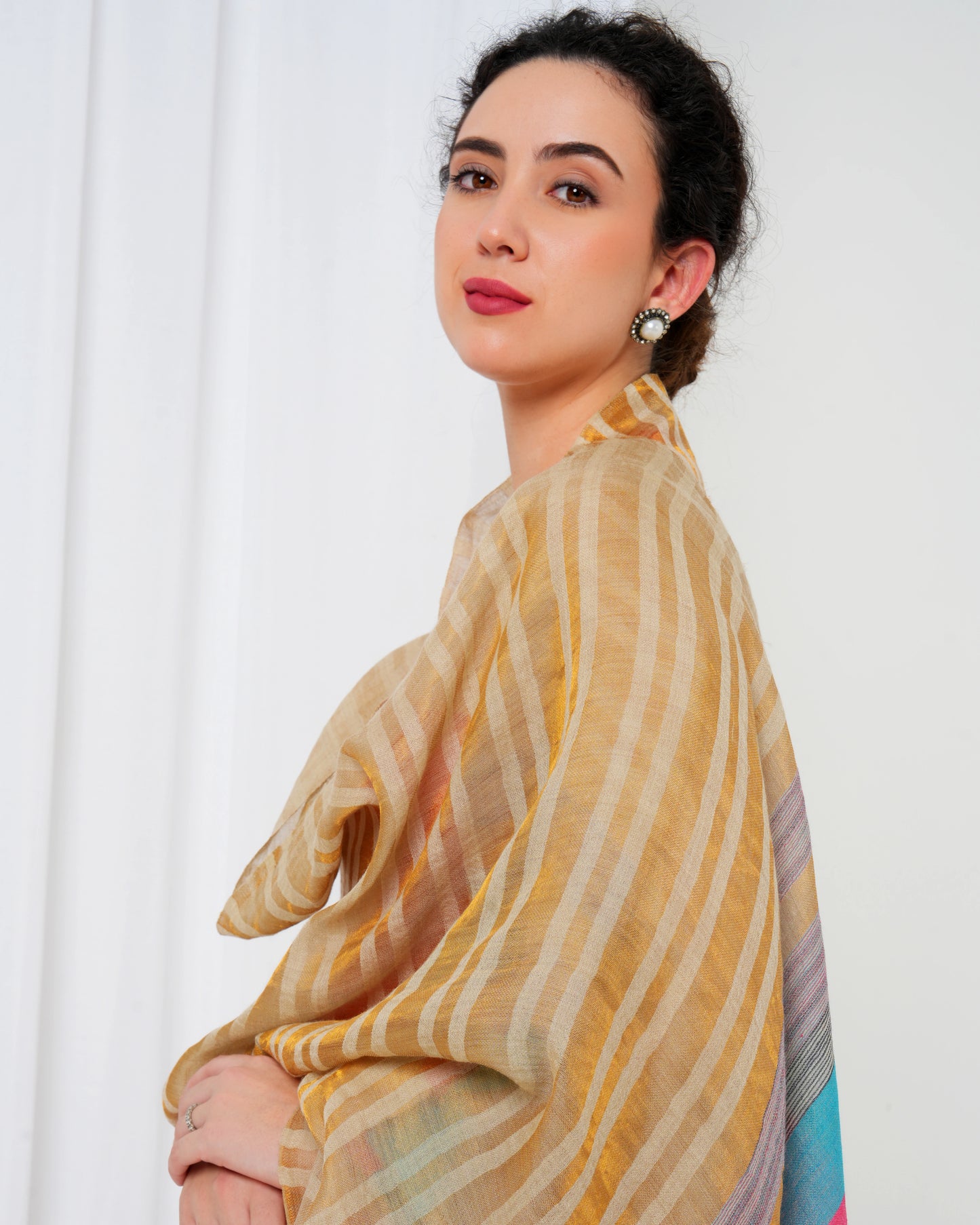 Woolen stole with cream base, and gold, pink, blue stripes