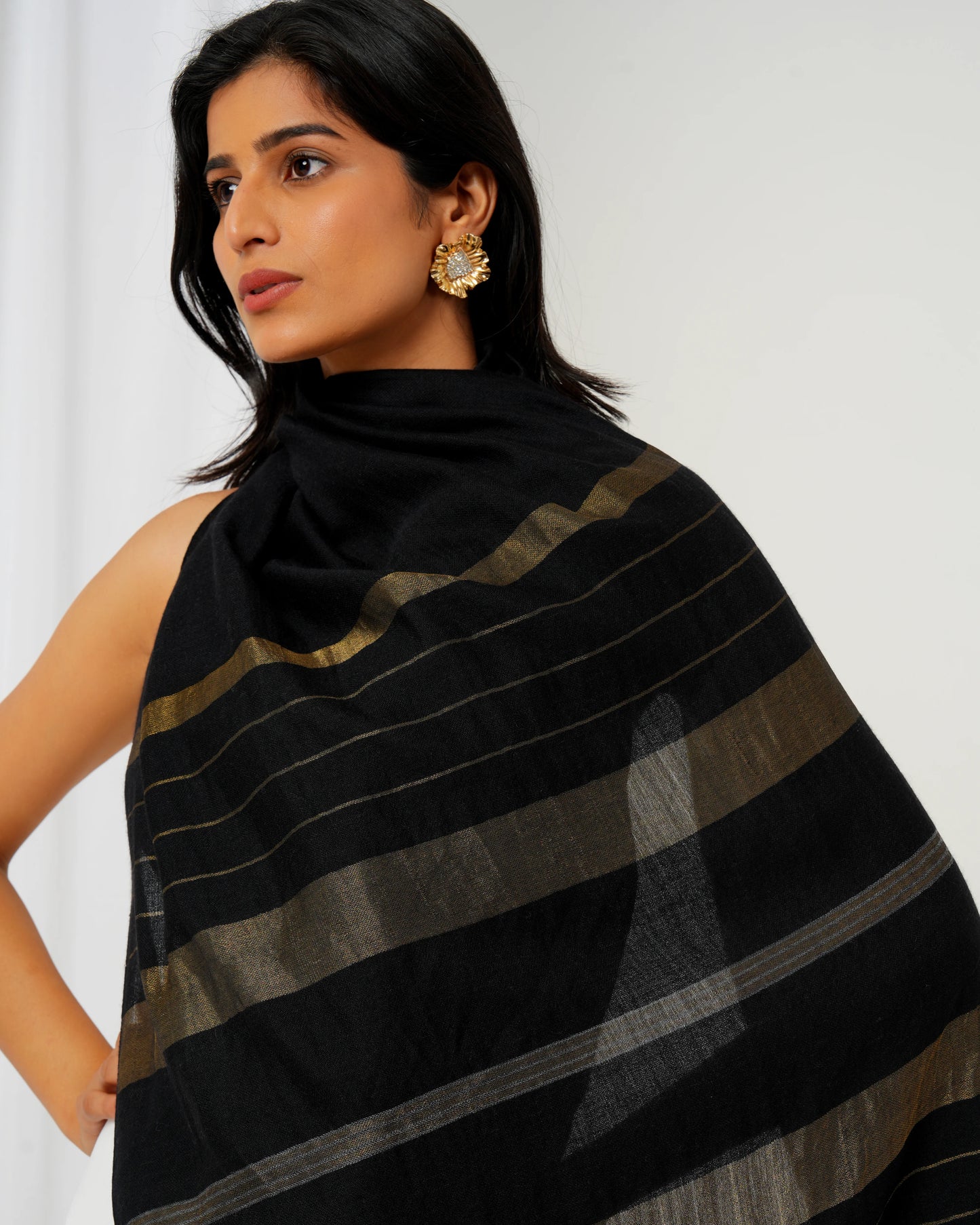 Cashmere stole in black base and multi shaped stripes in golden