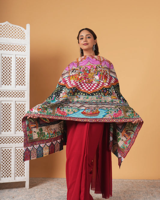 Woman wearing a colorful traditional outfit with a patterned shawl against a beige background