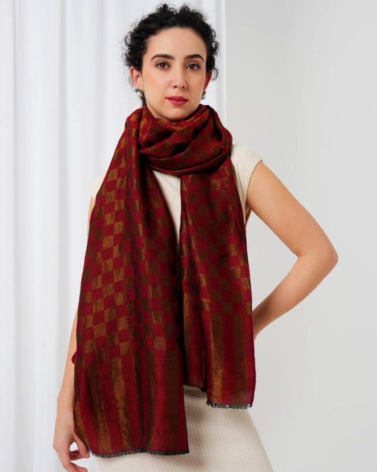 Woman wearing a red patterned scarf against a white background