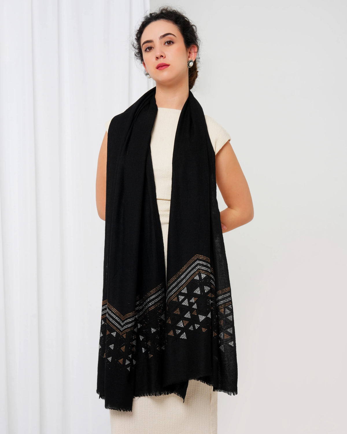 Woman wearing a black patterned scarf on a white background