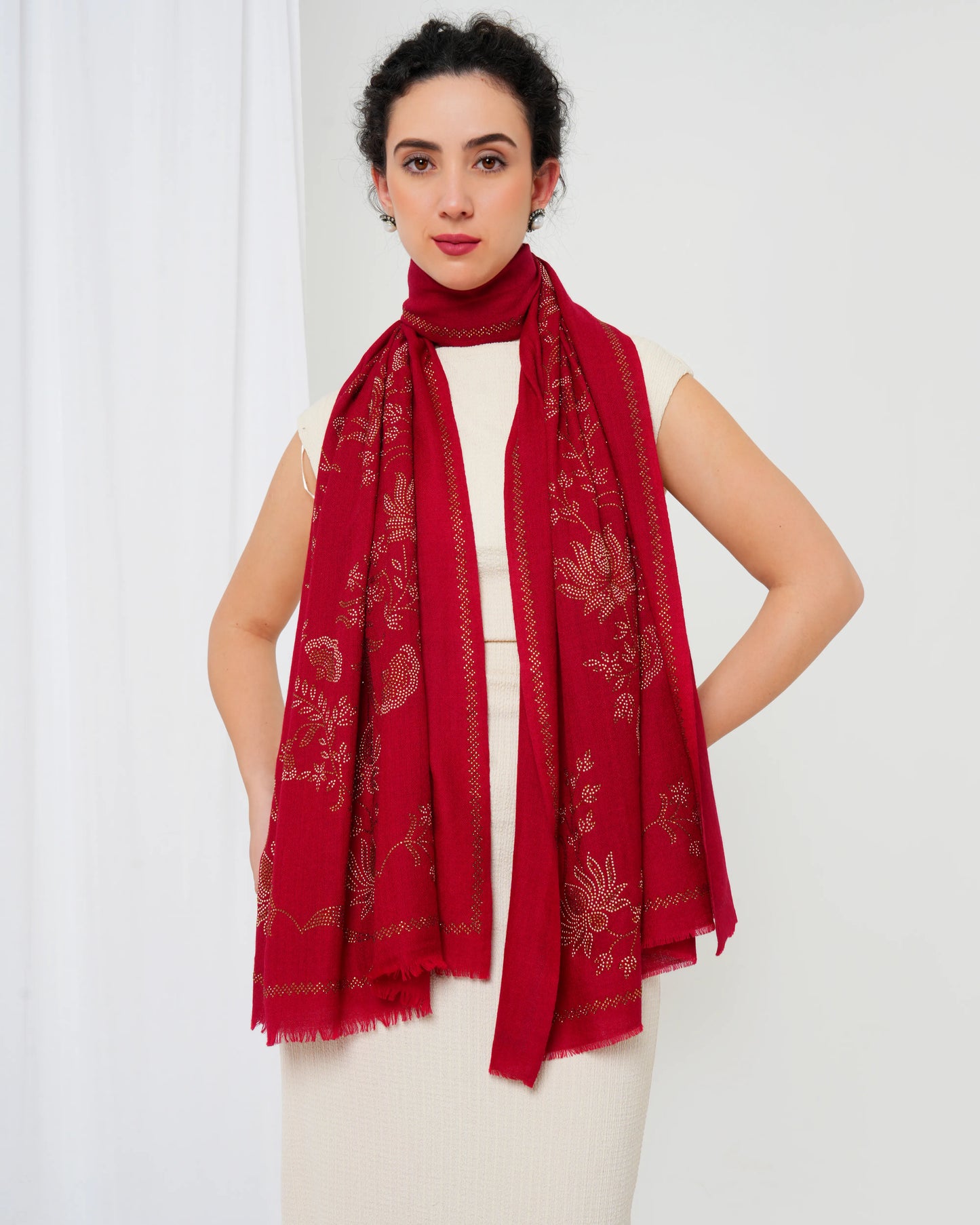 Woman wearing a red patterned scarf on a white background