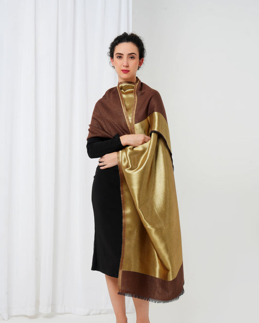 Woman wearing a brown and gold scarf against a white background