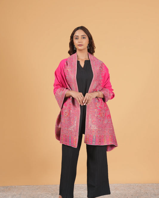 Woman wearing a pink patterned coat against a beige background