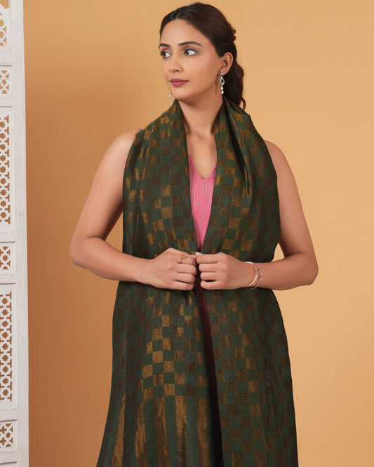 Woman wearing a green patterned scarf against a beige background